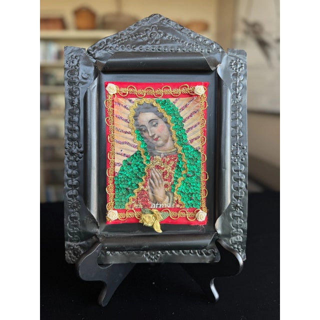 This vintage Mexican nicho shrine is a mixed-media devotional work assembled from metal, paper, and applied decorative...