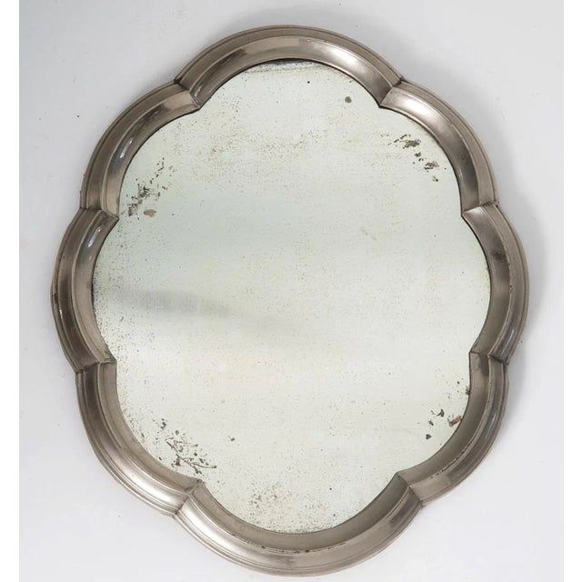 This is a unusual mirror made for decorating the table. The mirror is made with a frame in pewter in baroque style and...