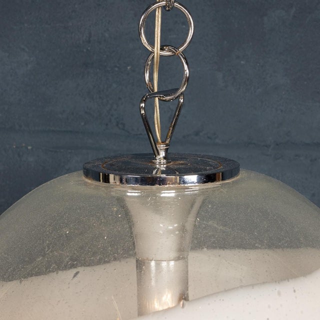 A 20th century white and clear murano glass pendant lamp, crafted in venice, italy, circa 1970. This lamp epitomises the...