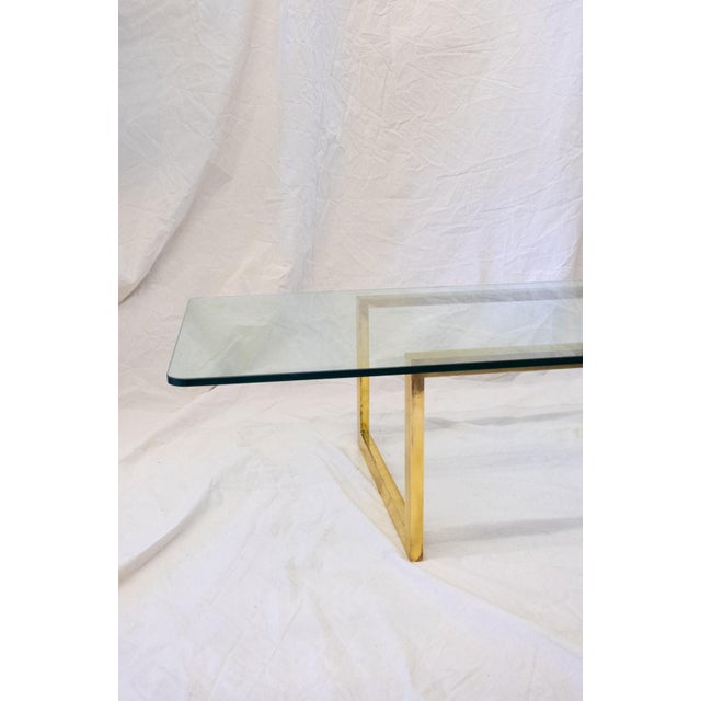 Brass and Glass Coffee Table – 1980s Polished brass structure with a clean geometric design supporting a rectangular clear...