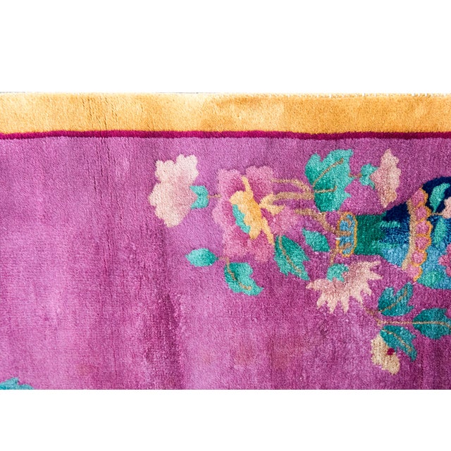 This vibrant 1930s Chinese Art Deco rug features a rich purple field framed by a contrasting mustard-gold border. The...