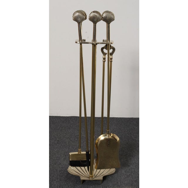 Vintage Hollywood Regency-style fireplace tool set in polished brass (ca. 1970s, USA). Complete set featuring a stand, log...