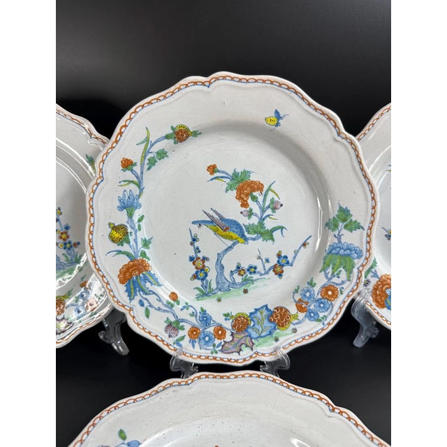 A charming set of four Italian faience plates with hand-painted polychrome bird and floral decoration in the traditional...