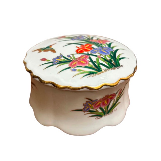A charming vintage Japanese porcelain trinket box featuring an elegant scalloped silhouette and beautifully hand-decorated...