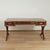 Handsome stylized campaign desk crafted in mahogany featuring three tooled leather panels on a brass banded case with...