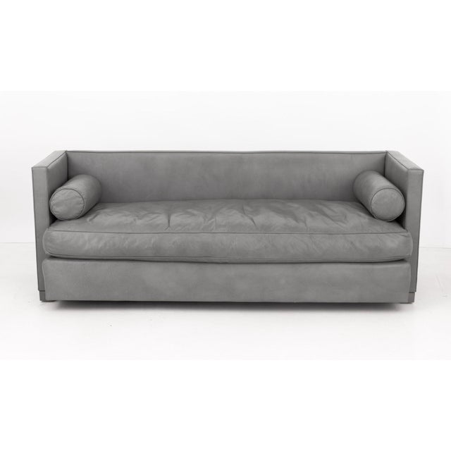 Modern Gray Leather Upholstered Three-Seat Sofa, with two bolster cushions. 30.5" H x 84" W x 33" D; seat: 19" H....