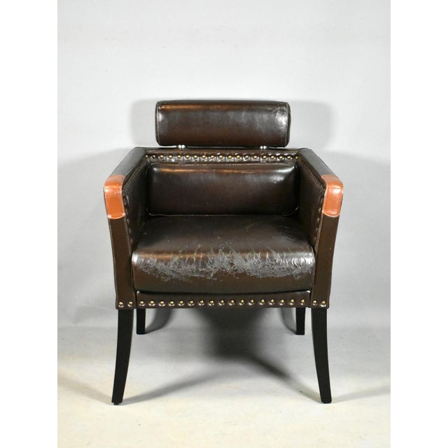 A very comfortable French Mid-Century Lounge Chair upholstered in leatherette (faux leather) and fixed with brass studs...