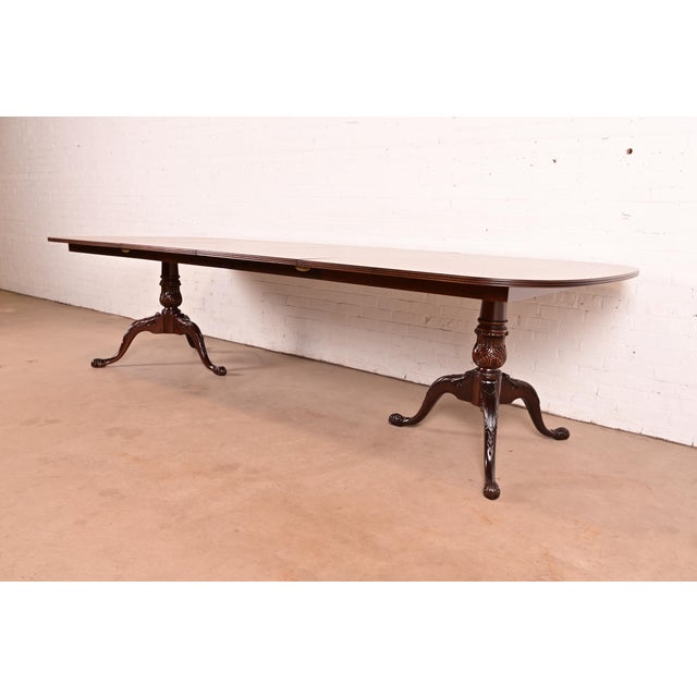 An exceptional Georgian or Chippendale style double pedestal extension dining table By Drexel Heritage USA, Late 20th...