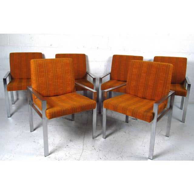 This set of six Mid-Century armchairs features wonderful vintage fabric, sturdy metal frames and comfortable design....