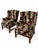 A striking matched pair of wingback armchairs upholstered in a black-ground floral pattern featuring red-and-cream...