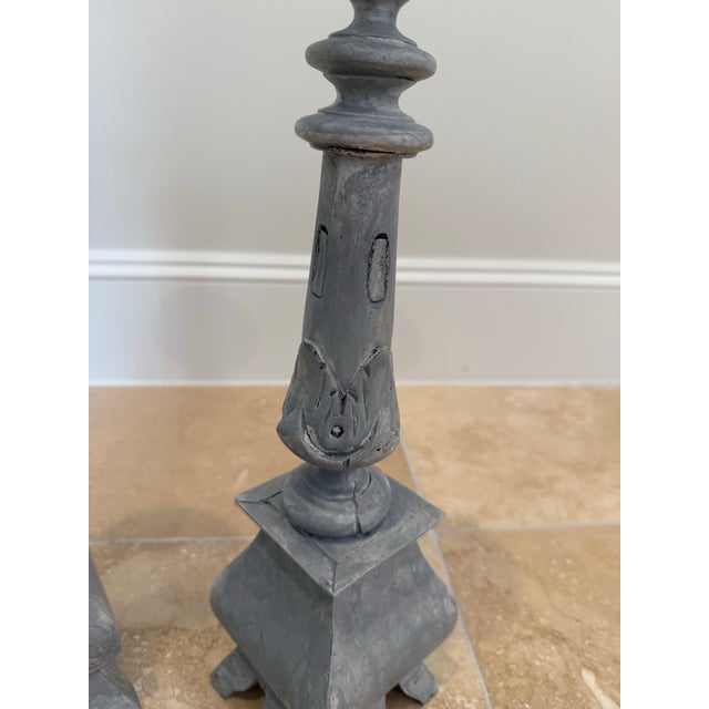 Pair of lovely wooden vintage candlesticks, painted in a gray wash. Stand 17” tall.