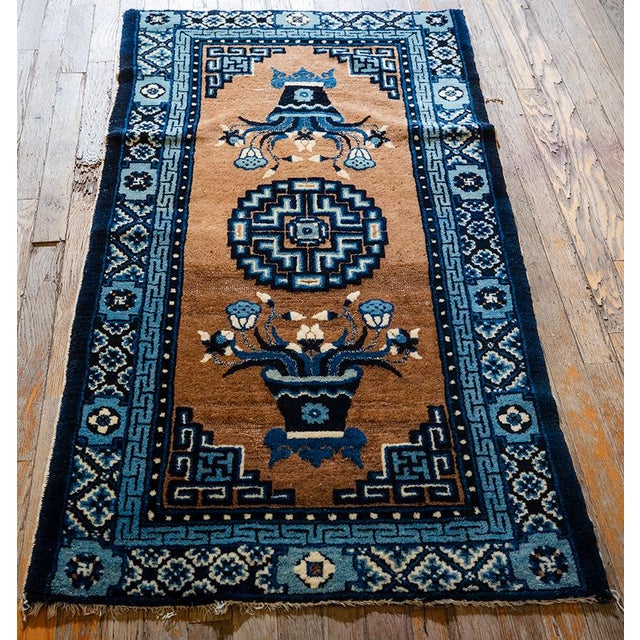 This 1920s Chinese Art Deco scatter rug is a hand-knotted wool piece measuring 4' 7" x 2' 7", featuring a rich brown...