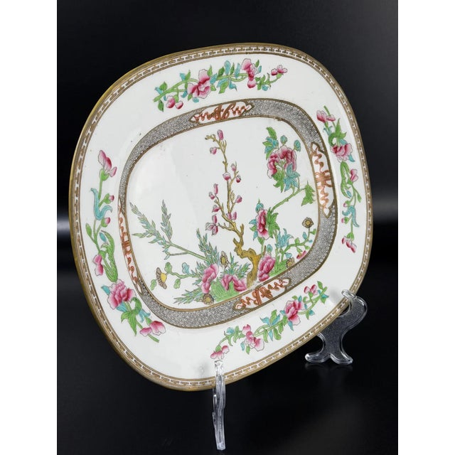 A refined late 19th century English porcelain serving platter in the Minton style. The piece features an elegant floral...
