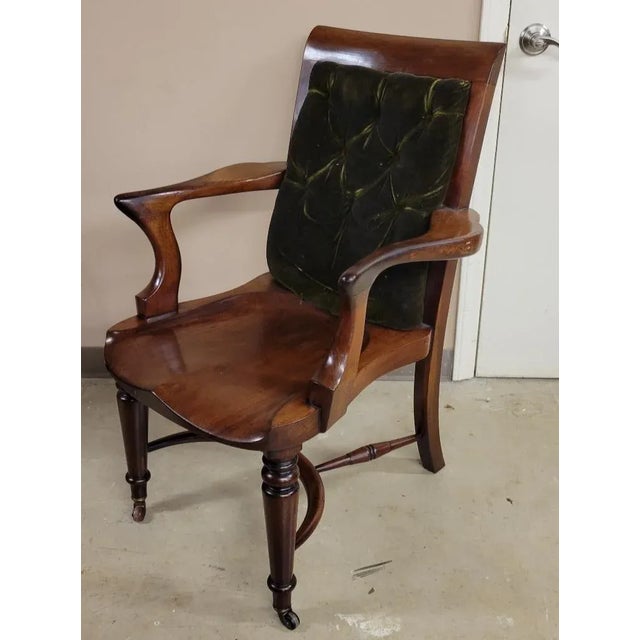 Circa 1900, French Art Nouveau walnut desk chair with very comfortable sculpted seat. The back is upholstered with a dark...