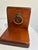 A well-made pair of wood bookends finished in a warm mahogany tone, each fitted with a polished brass ring pull as a...