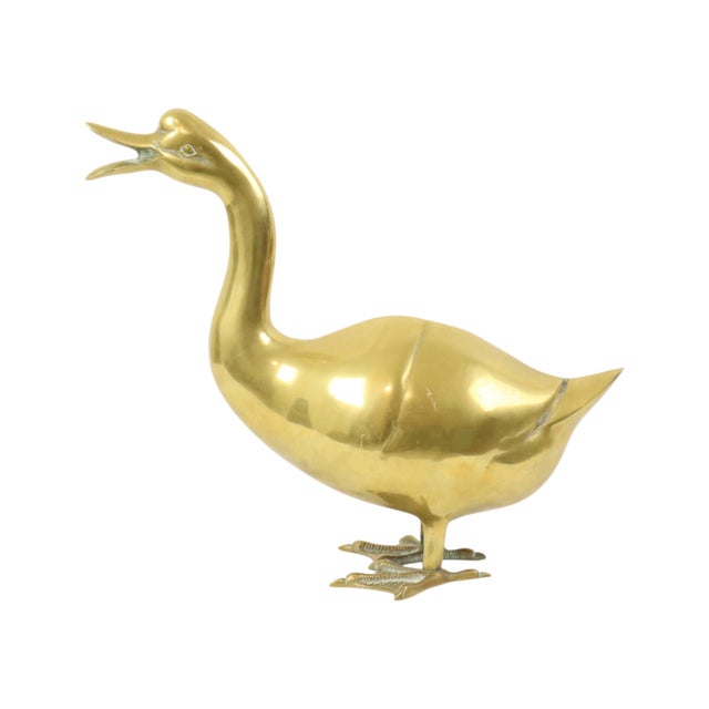 A beautiful, large sculpture of a quacking duck made of yellow copper—better known as brass. This is a Hollywood Regency...