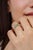 This delicate three-stone emerald ring is crafted in 925 sterling silver and features three vibrant round-cut emeralds...