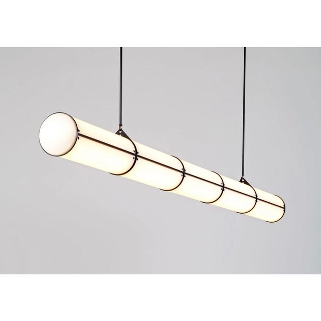 The Roll & Hill Endless Straight 5 Pendant by Jason Miller is a dramatic linear chandelier inspired by 1970s...