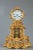 Mantel clock in gilt and sculpted bronze featuring abundant rocaille motifs such as rinceaux, shells, distressed leaves,...