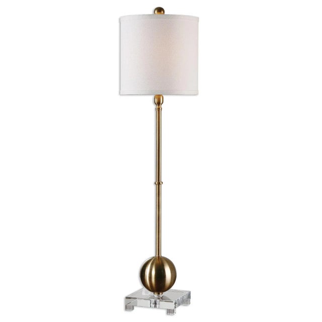 This Versatile Buffet Lamp Features Smooth Iron Details Finished In A Plated Brushed Brass, Accented With A Thick Crystal...