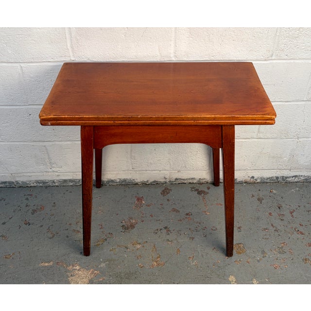 A distinctive pivot-top game table by Cushman, from the Colonial Creations line, combining traditional craftsmanship with...