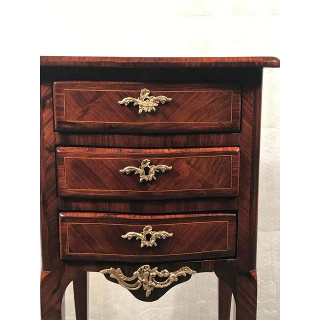 Small Rococo style chest of drawers or nightstand, France 19th century. This beautiful small dresser has a gorgeous...
