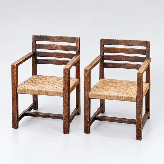 Modernist vintage armchairs (2 available). A distinctive set of two modernist-style vintage armchairs, crafted from dark...