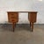 A compact Danish teak writing desk from the 1960s with an especially useful arrangement of storage built into the form....