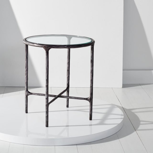 Introducing the Jessa forged metal round end table in a sleek black finish. This stunning piece offers a blend of modern...