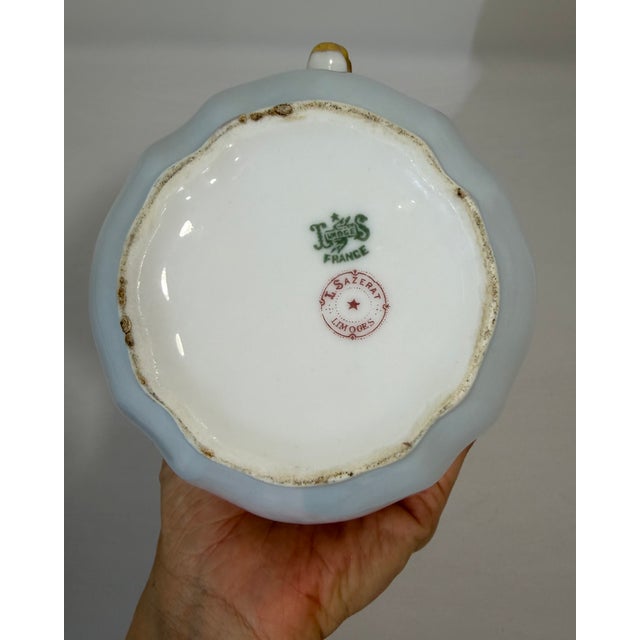 Elegant antique French Limoges porcelain teapot dating to the late 19th century, circa 1890. The pot features a soft pale...