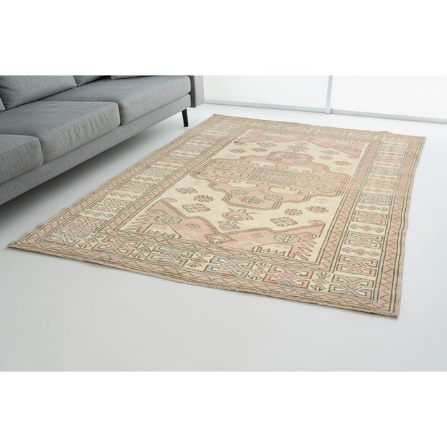 Add a touch of timeless elegance and warmth to your home with this beautiful, hand-knotted vintage Turkish rug. Featuring...