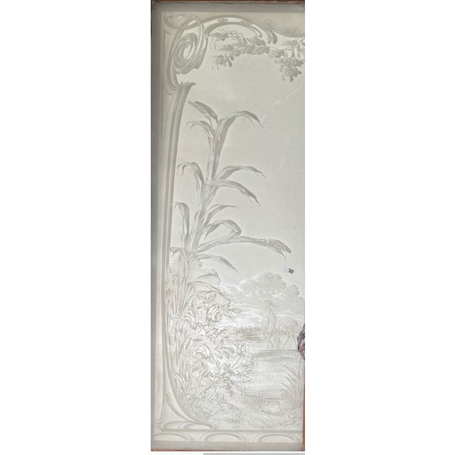 Large pair of French acid-etched glass doors set within a wood frame featuring faux painted woodgraining. The etched glass...