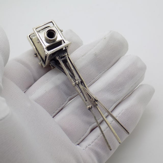 A striking and unusual miniature, this vintage Italian piece represents a classic tripod camera, rendered in solid...