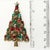 Vintage Christmas tree with traditional red and green rhinestones. Metal is gold plated. Marked Pakula. We believe this...