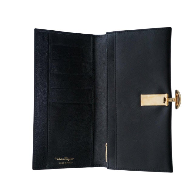 Salvatore Ferragamo Gancini Icona Black Continental Wallet, a blend of classic design and modern functionality. Crafted...