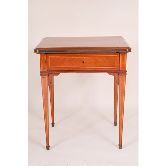 Louis XVI style tulip wood and king wood fold over games table, circa 1930's. The top with a central star inlay, aprons...
