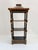 Vintage Chinoiserie pagoda wall shelf constructed of black lacquer wood with painted gold gilt detailing. Features a...
