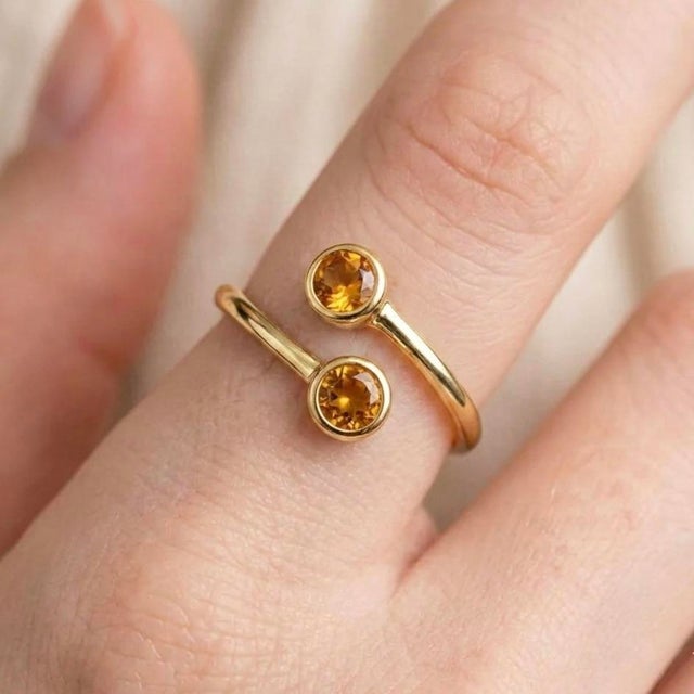Citrine Open Band Ring This elegant ring highlights the radiant beauty of citrine gemstones, celebrated for their warm...
