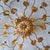 This gilt metal metal ceiling lamp with a diameter of 75 cm features branches with leaves and crystal flowers and has 8...
