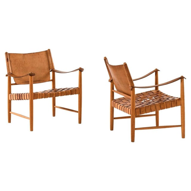 This rare pair of easy chairs, produced in sweden during the 1950s, embodies key elements of scandinavian modern design...