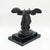 A striking Dalí resin sculpture depicting Two Nikes / La Double Victoire de Samothrace, presented on a contrasting marble...