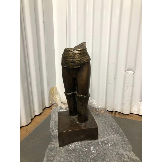 A compelling and thought-provoking abstract bronze sculpture celebrating the strength, grace, and movement of the female...