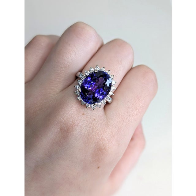 Make an unforgettable impression with this luxurious 8.93 carat oval 13x10mm Tanzanite ring. Nestled in a halo of...