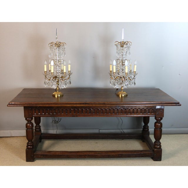 Pair of large six-light candelabra in gilt bronze with crystal pendants. Gilt bronze base decorated with laurel leaves and...