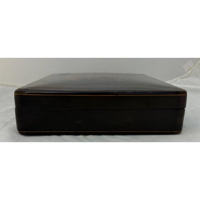 This vintage early 1900’s French gambling game box is designed in rich stained poplar wood. It is decorated with a...