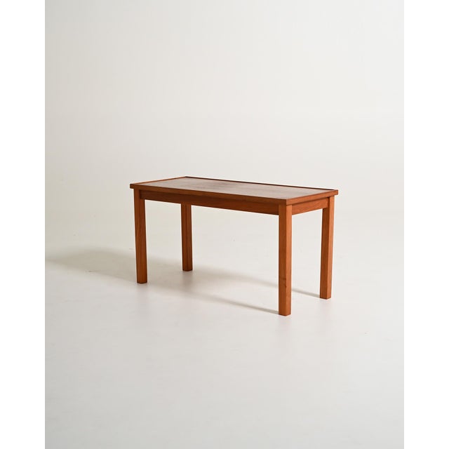 Teak coffee table. Scandinavian production, 1960s. Coffee table produced in Scandinavia in the 1960s. The top is enclosed...