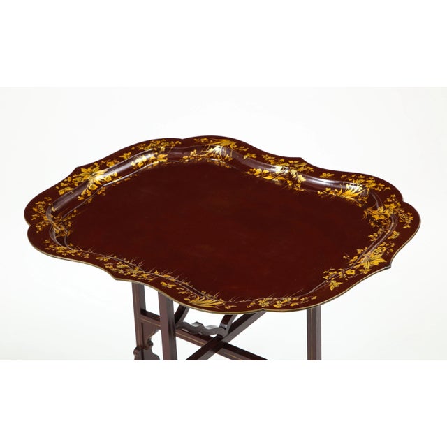 The rectangular tray with scalloped edges and deep bordered decorated in gilt with clumps of flowers and butterflies;...