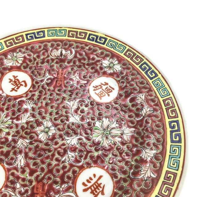This is a Chinese Mun Shou plate. This small-sized plate is adorned with traditional Chinese longevity characters and...