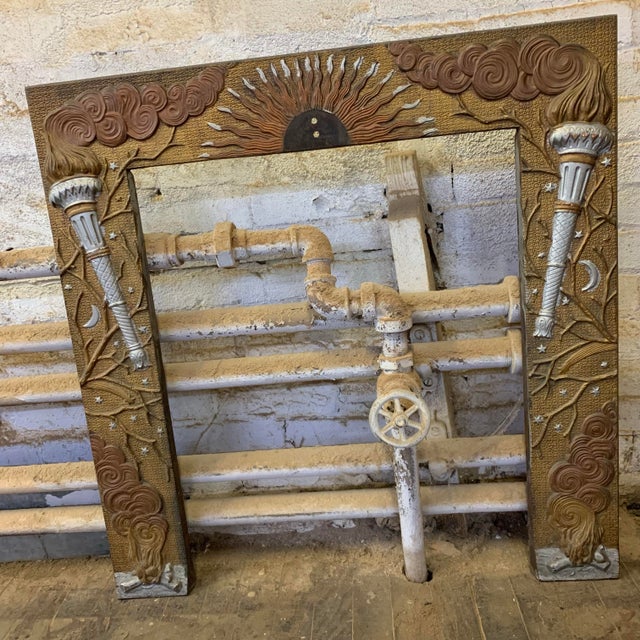 Incredible cast iron fireplace surround that features a night and day motif with sun, stars, torches and fire wood piles....