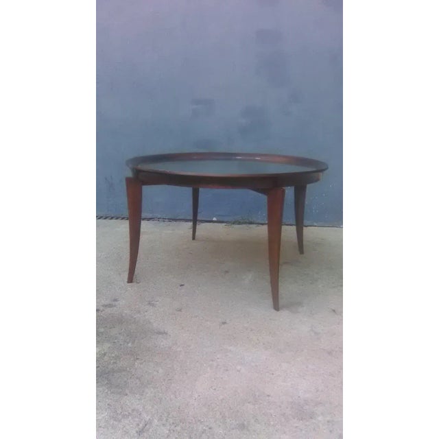 Old solid walnut coffee table and mirror of the 30s. The hue on the edge of the mirror is worn, which is why there is a...